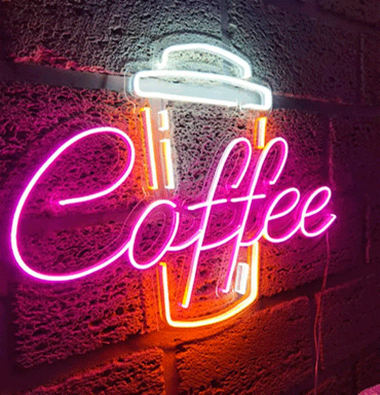 Coffee cup neon sign mounted on café wall