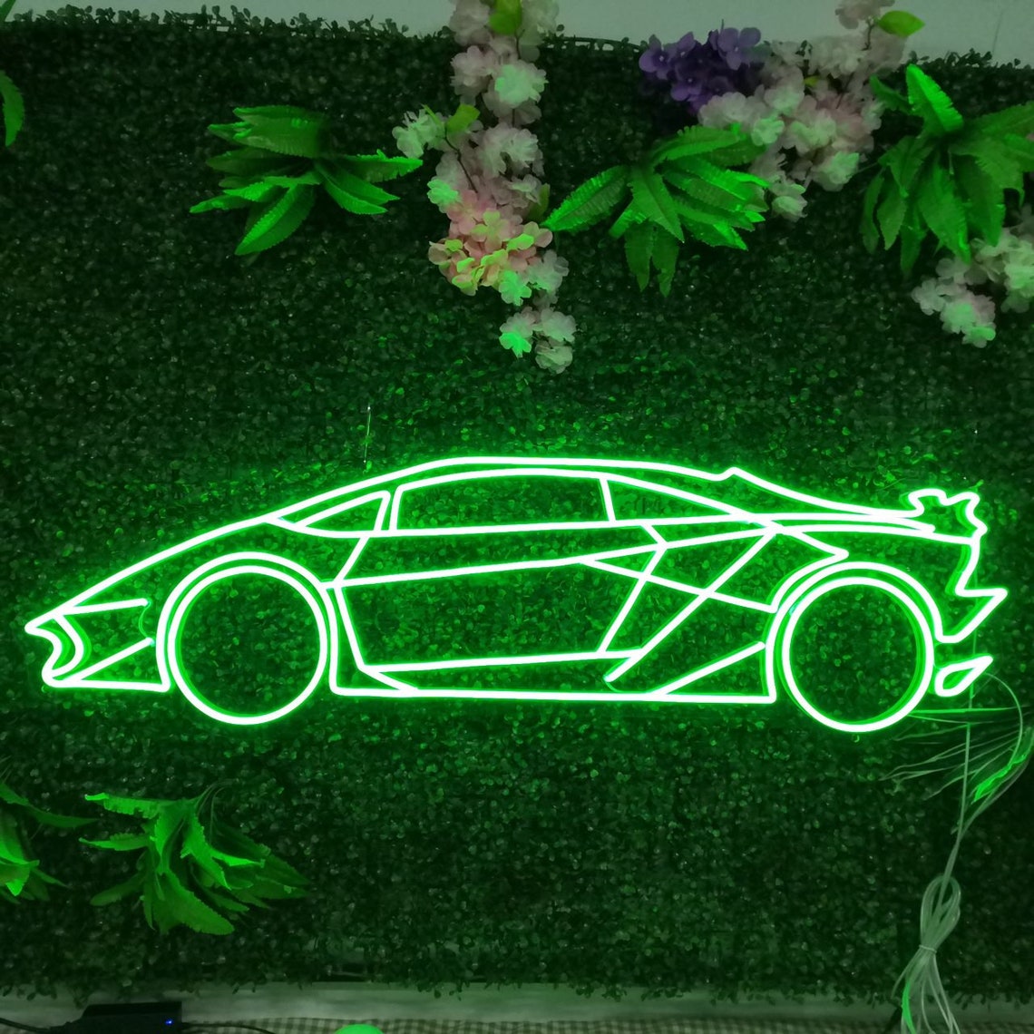 Sports car neon sign used as modern wall décor light up in green light