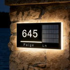 solar address sign with numbers and address name mounted on a brick wall